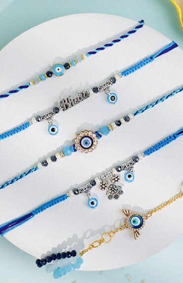 Assorted Evil Eye Rakhis in blue thread with charms and beads – Kala Rakhi