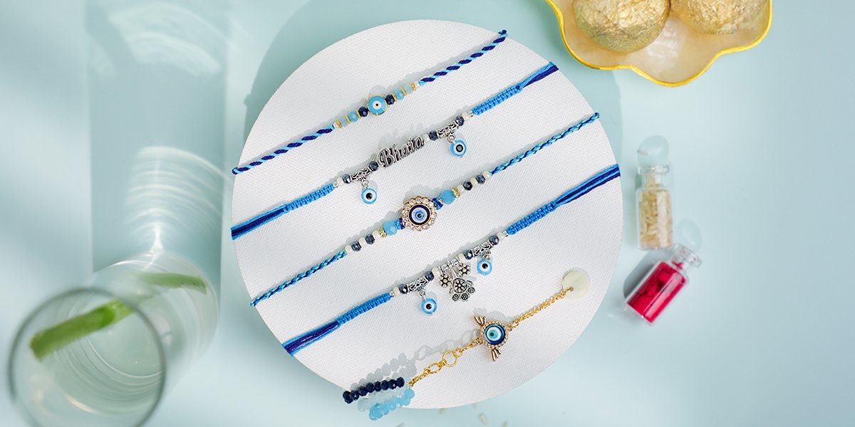 Assorted Evil Eye Rakhis in blue thread with charms and beads – Kala Rakhi