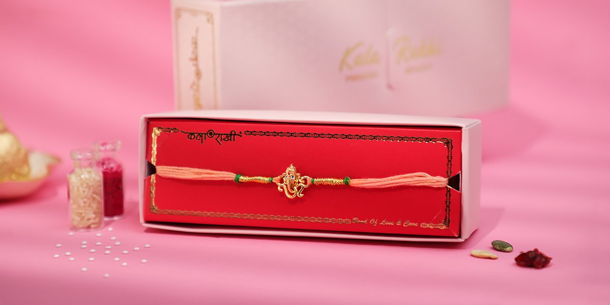 Premium God Rakhi with Lord Ganesha charm and saffron thread by Kala Rakhi