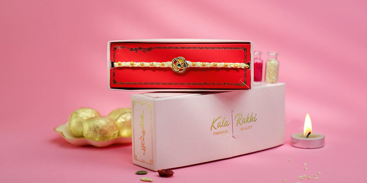 Traditional Kundan Rakhi with white thread and multicolor stone centerpiece – handcrafted by Kala Rakhi